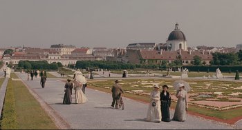 Movie still from “A Dangerous Method” (2011), directed by David Cronenberg – A group of people walking down a sidewalk; Extreme Wide shot, High angle