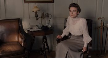 Movie still from “A Dangerous Method” (2011), directed by David Cronenberg – A woman sitting in a chair in a room; Medium shot, High angle