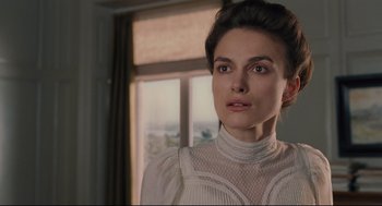 Movie still from “A Dangerous Method” (2011), directed by David Cronenberg – A woman in a white dress standing in front of a window; Close Up shot, Over the shoulder angle