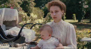 Movie still from “A Dangerous Method” (2011), directed by David Cronenberg – A woman holding a baby in her arms; Close Up shot, Low angle