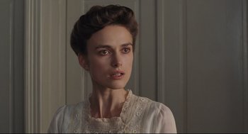Movie still from “A Dangerous Method” (2011), directed by David Cronenberg – A woman in a white dress looking at the camera; Close Up shot, Over the shoulder angle