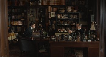 Movie still from “A Dangerous Method” (2011), directed by David Cronenberg – A man and woman sitting at a table in a room; Wide shot, High angle