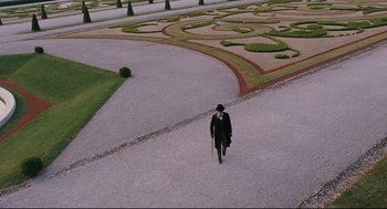 Movie still from “A Dangerous Method” (2011), directed by David Cronenberg – A man walking down a path in the middle of a garden; Extreme Wide shot, High angle