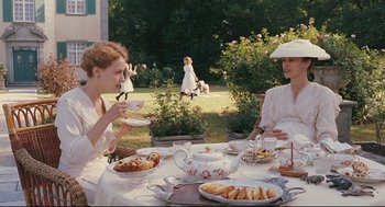 Movie still from “A Dangerous Method” (2011), directed by David Cronenberg – Two women are sitting at a table with food; Medium shot, Over the shoulder angle