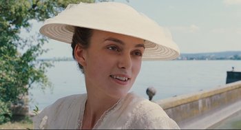 Movie still from “A Dangerous Method” (2011), directed by David Cronenberg – A woman wearing a white hat near a body of water; Close Up shot, Over the shoulder angle