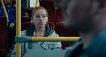 Movie still from “A Date for Mad Mary” (2016), directed by Darren Thornton – A woman sitting on a bus listening to music; Close Up shot, Over the shoulder angle