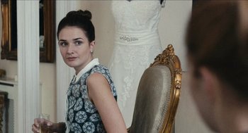 Movie still from “A Date for Mad Mary” (2016), directed by Darren Thornton – A young woman posing in front of a wedding dress; Close Up shot, Over the shoulder angle