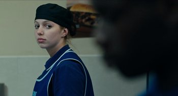 Movie still from “A Date for Mad Mary” (2016), directed by Darren Thornton – A woman wearing a black hat and a blue shirt; Close Up shot, Over the shoulder angle
