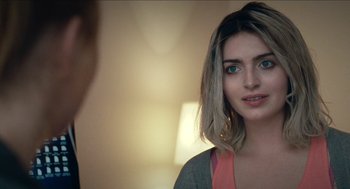 Movie still from “A Date for Mad Mary” (2016), directed by Darren Thornton – A beautiful young woman with shoulder - length blonde hair; Close Up shot, Over the shoulder angle
