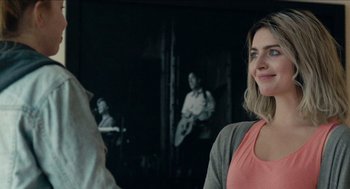 Movie still from “A Date for Mad Mary” (2016), directed by Darren Thornton – A woman standing in front of a man in a room; Close Up shot, Over the shoulder angle