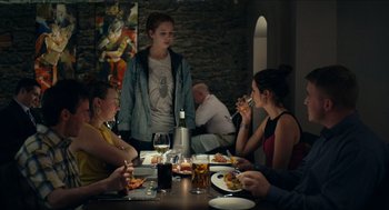 Movie still from “A Date for Mad Mary” (2016), directed by Darren Thornton – A group of people sitting around a table eating; Medium shot, Over the shoulder angle