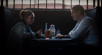 Movie still from “A Date for Mad Mary” (2016), directed by Darren Thornton – A man and a woman sitting at a table; Medium shot, Over the shoulder angle