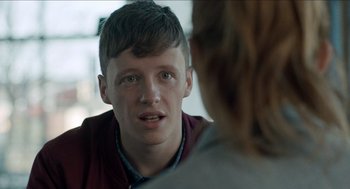 Movie still from “A Date for Mad Mary” (2016), directed by Darren Thornton – A young man talking to a woman in a room; Close Up shot, Over the shoulder angle