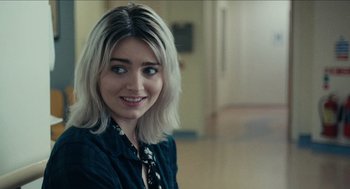 Movie still from “A Date for Mad Mary” (2016), directed by Darren Thornton – A woman with blonde hair wearing a blue shirt; Close Up shot, Over the shoulder angle