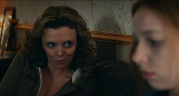 Movie still from “A Date for Mad Mary” (2016), directed by Darren Thornton – A person sitting on a couch; Close Up shot, Over the shoulder angle