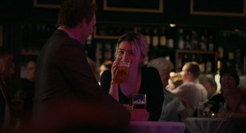 Movie still from “A Date for Mad Mary” (2016), directed by Darren Thornton – A man and a woman sitting at a table drinking beer; Medium shot, Over the shoulder angle