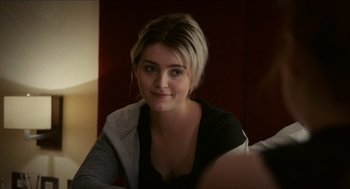 Movie still from “A Date for Mad Mary” (2016), directed by Darren Thornton – A woman sitting in front of a camera smiling for the camera; Close Up shot, Over the shoulder angle