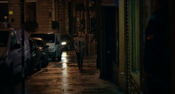 Movie still from “A Date for Mad Mary” (2016), directed by Darren Thornton – A woman walking down a street at night; Extreme Wide shot, Over the shoulder angle