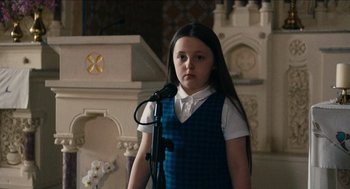 Movie still from “A Date for Mad Mary” (2016), directed by Darren Thornton – A young girl standing in front of a microphone; Medium shot, Over the shoulder angle
