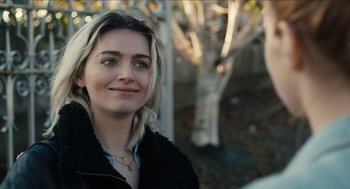 Movie still from “A Date for Mad Mary” (2016), directed by Darren Thornton – A beautiful young lady smiling for the camera; Close Up shot, Over the shoulder angle