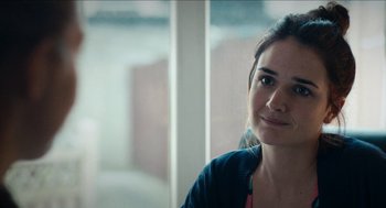 Movie still from “A Date for Mad Mary” (2016), directed by Darren Thornton – A person sitting in front of a window; Close Up shot, Over the shoulder angle
