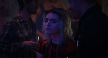 Movie still from “A Date for Mad Mary” (2016), directed by Darren Thornton – A woman with blonde hair is looking at the camera; Close Up shot, Over the shoulder angle