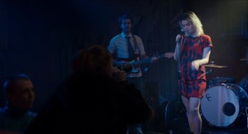 Movie still from “A Date for Mad Mary” (2016), directed by Darren Thornton – A man and a woman singing and playing a guitar; Medium shot, Over the shoulder angle