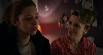 Movie still from “A Date for Mad Mary” (2016), directed by Darren Thornton – A woman sitting next to a young girl in a room; Close Up shot, Over the shoulder angle