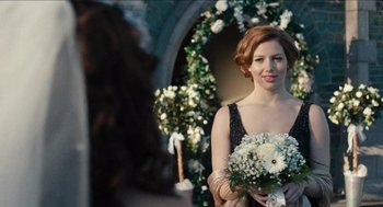 Movie still from “A Date for Mad Mary” (2016), directed by Darren Thornton – A beautiful woman holding a bouquet of flowers in her hand; Close Up shot, Over the shoulder angle