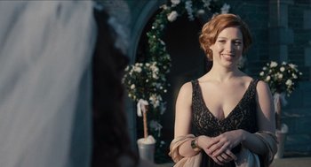 Movie still from “A Date for Mad Mary” (2016), directed by Darren Thornton – A woman in a black dress smiling for the camera; Close Up shot, Over the shoulder angle