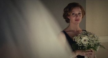 Movie still from “A Date for Mad Mary” (2016), directed by Darren Thornton – A beautiful young lady holding a bouquet of flowers; Close Up shot, Low angle