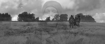 Movie still from “A Field in England” (2013), directed by Ben Wheatley – A man in a field with a gun and a horse; Wide shot, Low angle