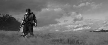 Movie still from “A Field in England” (2013), directed by Ben Wheatley – A man standing in the middle of an open field; Extreme Wide shot, Low angle
