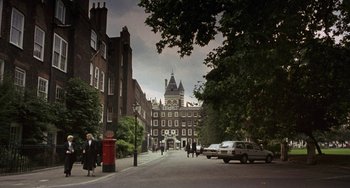 Movie still from “A Fish Called Wanda” (1988), directed by Charles Crichton – People walking down the street in front of a building; Extreme Wide shot, High angle