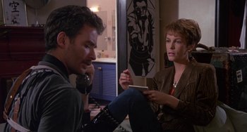 Movie still from “A Fish Called Wanda” (1988), directed by Charles Crichton – A man and a woman sitting on the floor talking; Medium shot, Low angle