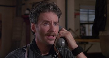 Movie still from “A Fish Called Wanda” (1988), directed by Charles Crichton – A person talking on a phone; Close Up shot, Low angle