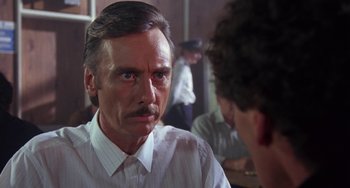 Movie still from “A Fish Called Wanda” (1988), directed by Charles Crichton – An older man with a mustache talking to a younger man; Close Up shot, Over the shoulder angle