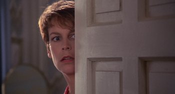 Movie still from “A Fish Called Wanda” (1988), directed by Charles Crichton – A person standing in front of a door; Close Up shot, Low angle