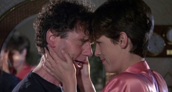 Movie still from “A Fish Called Wanda” (1988), directed by Charles Crichton – Two people touching each other's face with their eyes closed; Close Up shot, Over the shoulder angle