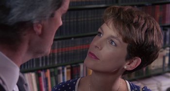 Movie still from “A Fish Called Wanda” (1988), directed by Charles Crichton – A man and a woman talking in front of a book shelf; Close Up shot, Over the shoulder angle