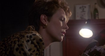 Movie still from “A Fish Called Wanda” (1988), directed by Charles Crichton – A person wearing a leopard print jacket; Close Up shot, Over the shoulder angle