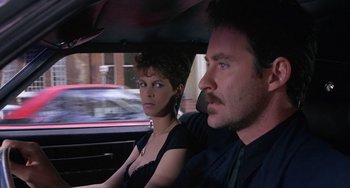 Movie still from “A Fish Called Wanda” (1988), directed by Charles Crichton – A man and a woman sitting in a car; Close Up shot, Over the shoulder angle