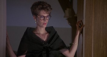 Movie still from “A Fish Called Wanda” (1988), directed by Charles Crichton – A woman in a black dress holding a cell phone; Close Up shot, Low angle