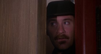 Movie still from “A Fish Called Wanda” (1988), directed by Charles Crichton – A person wearing a hat; Close Up shot, Low angle