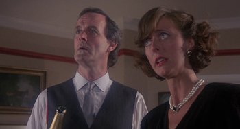 Movie still from “A Fish Called Wanda” (1988), directed by Charles Crichton – A man and a woman standing next to each other; Close Up shot, Low angle