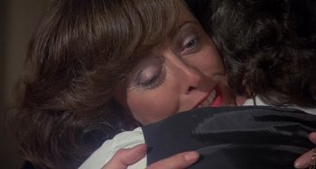 Movie still from “A Fish Called Wanda” (1988), directed by Charles Crichton – A person holding a bag; Close Up shot, Over the shoulder angle