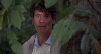 Movie still from “A Fish Called Wanda” (1988), directed by Charles Crichton – A person near a tree; Close Up shot, Low angle