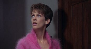 Movie still from “A Fish Called Wanda” (1988), directed by Charles Crichton – A person wearing a pink sweater; Close Up shot, Low angle