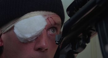 Movie still from “A Fish Called Wanda” (1988), directed by Charles Crichton – A man with a bandage on his left eye; Close Up shot, Low angle