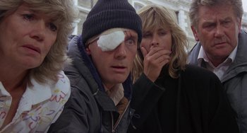 Movie still from “A Fish Called Wanda” (1988), directed by Charles Crichton – A man with an eye patch on his head; Close Up shot, Low angle